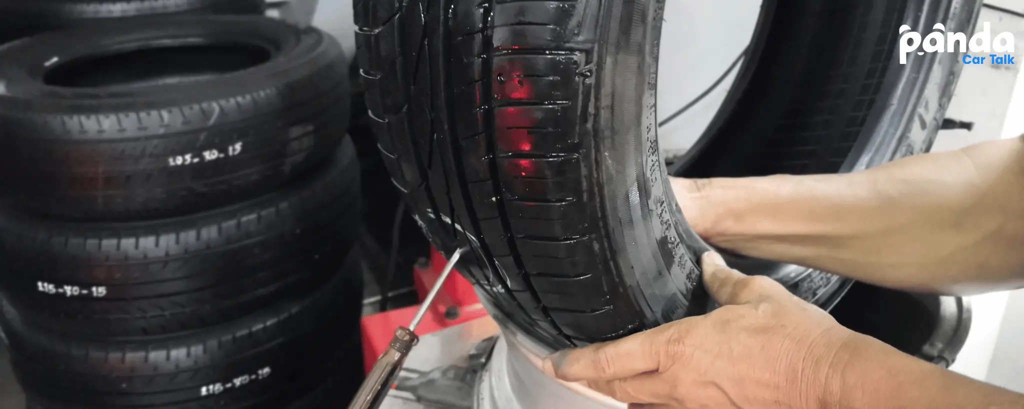 A mechanic finding and fixing a tire patch